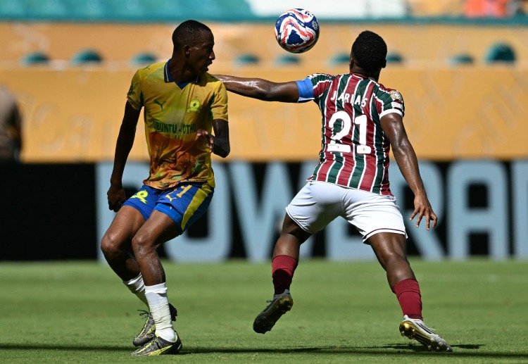 Jhon Arias and Divine Lunga battle for possession in the Club World Cup clash between Mamelodi Sundowns and Fluminense